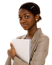 A woman in business-wear holding a binder in her hands.